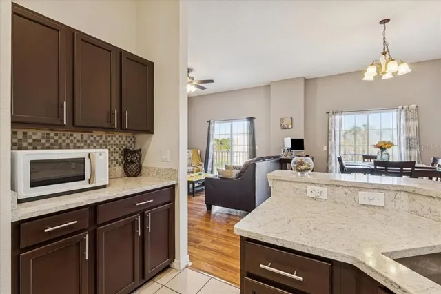 a large kitchen with stainless steel appliances wooden cabinets a stove and a center island