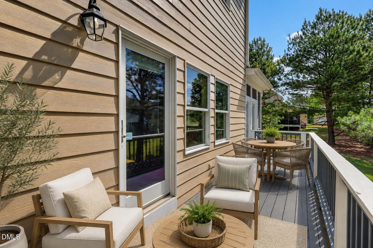 261 Character Drive Rolesville, NC 27571 - Photo 63 of 77 a view of a patio with couches table and chairs and potted plants
