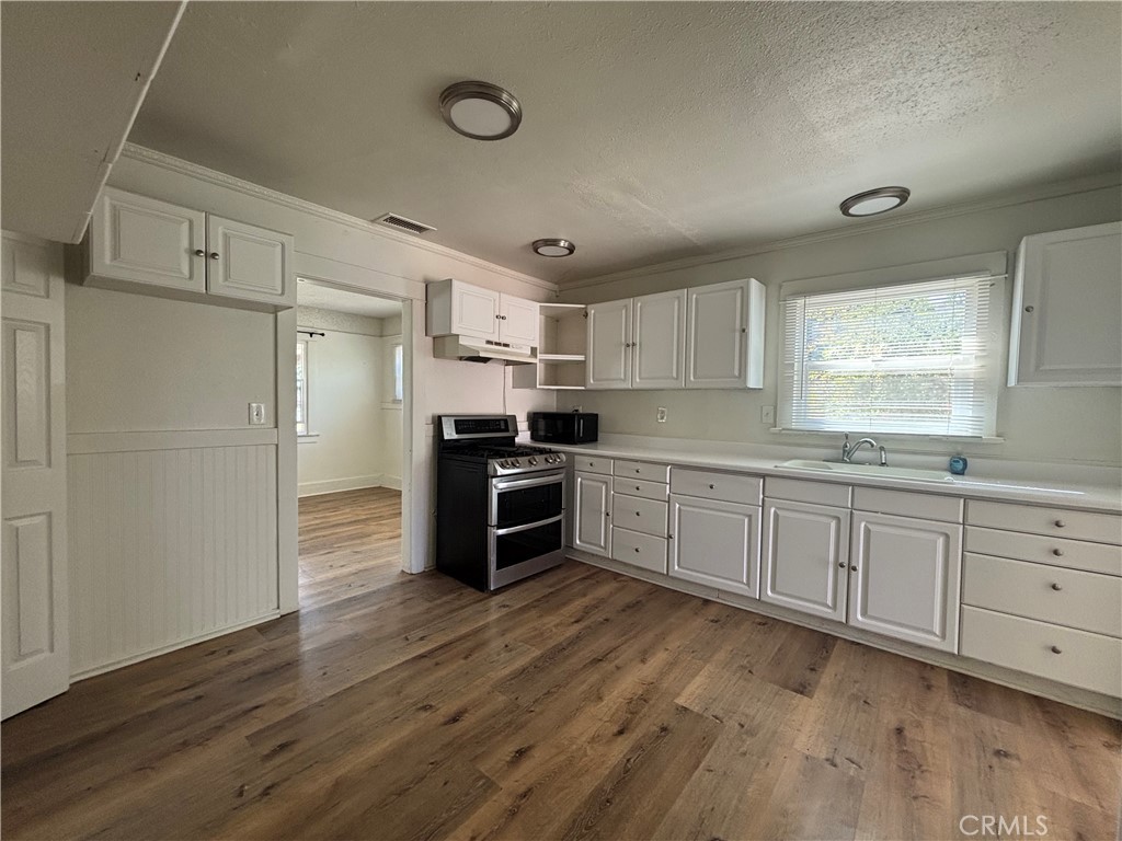 4793 Grove Riverside Ca Riverside, CA 92507 - Photo 12 of 23 a kitchen with granite countertop a refrigerator and a stove top oven