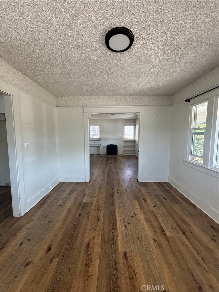 4793 Grove Riverside Ca Riverside, CA 92507 - Photo 18 of 23 an empty room with wooden floor and windows
