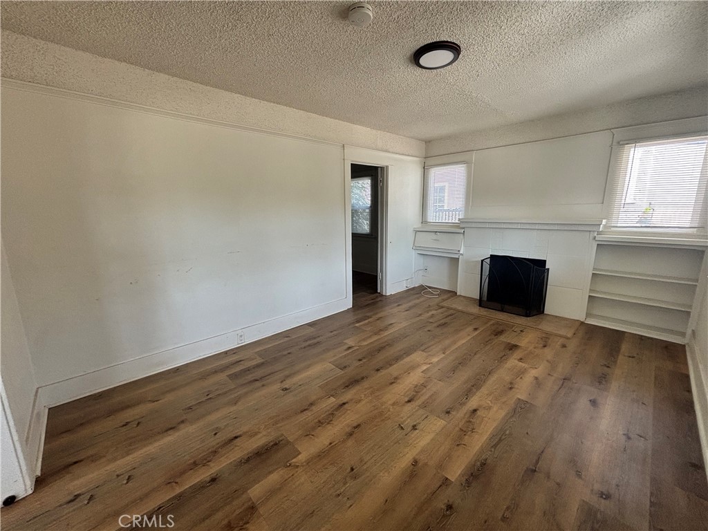 4793 Grove Riverside Ca Riverside, CA 92507 - Photo 2 of 23 a view of empty room with wooden floor and fan