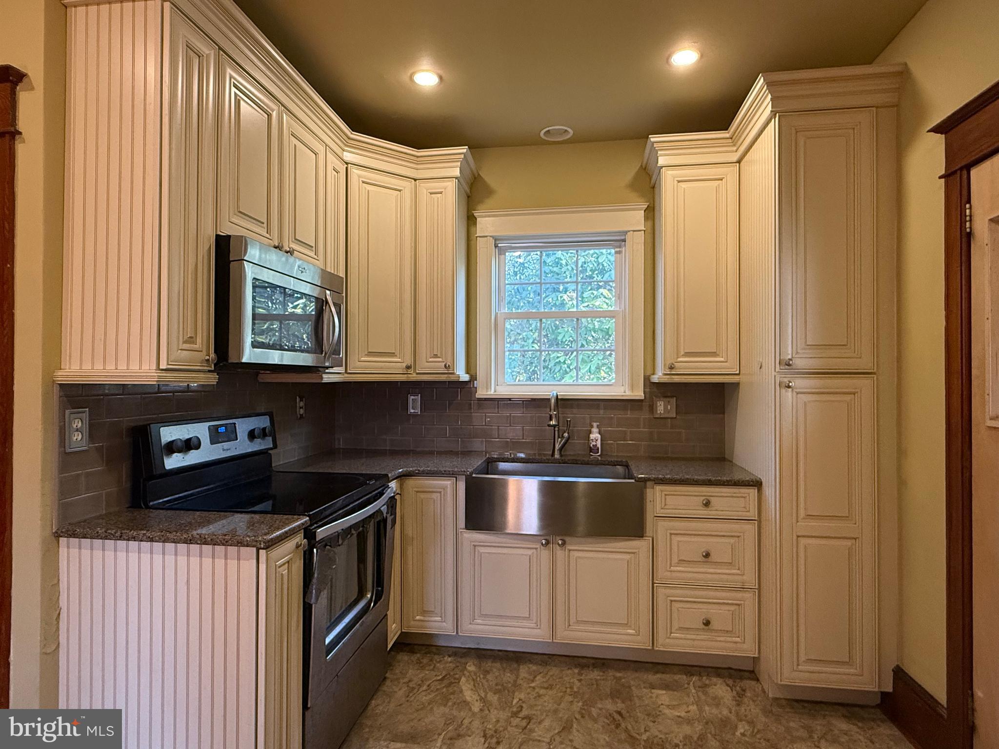 8340 Interchange Road Lehighton, PA 18235 - Photo 84 of 87 a kitchen with stainless steel appliances granite countertop a stove a sink and a microwave
