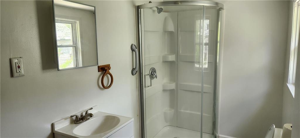 2014 5th Street Cardale, PA 15420 - Photo 9 of 11 a bathroom with a granite countertop sink a mirror and shower