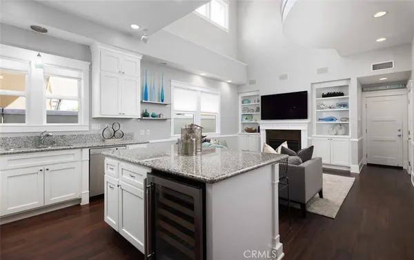 a kitchen with granite countertop a sink and a stove top oven with wooden floor