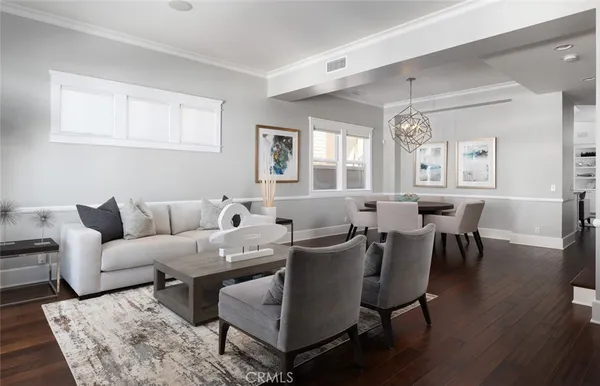a living room with furniture wooden floor and a window