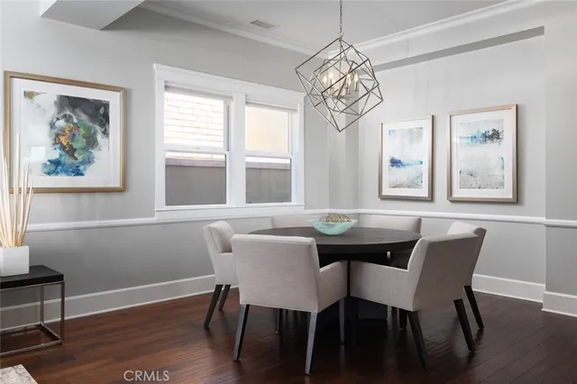 a view of a dining room with furniture wooden floor and a chandelier
