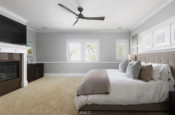 a bedroom with a bed and a television