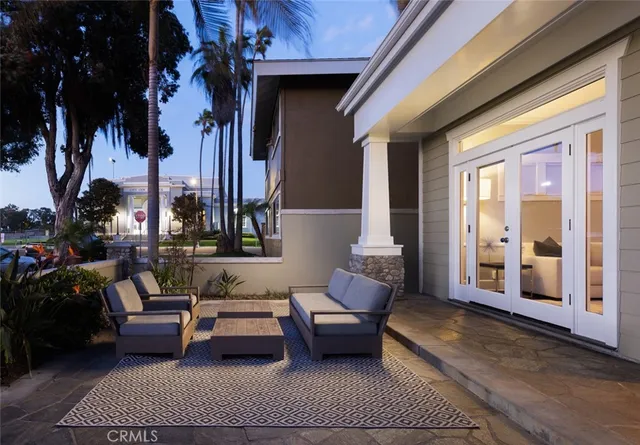 a balcony with furniture and a potted plant