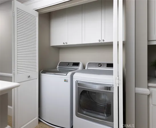 a view of a hallway to room with wooden floor and windows