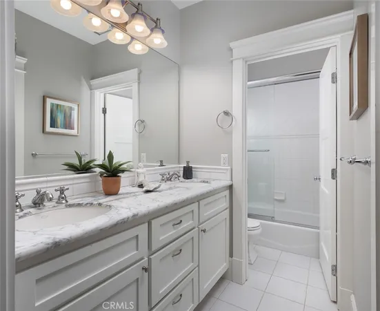 a large bed sitting in a bedroom next to a window