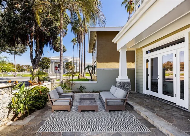a front view of a house with a garden and swimming pool