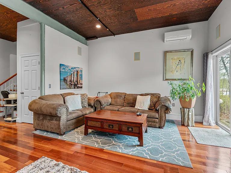 15 Riverview Avenue, Unit D Mashpee, MA 02649 - Photo 3 of 33 a living room with furniture and a potted plant