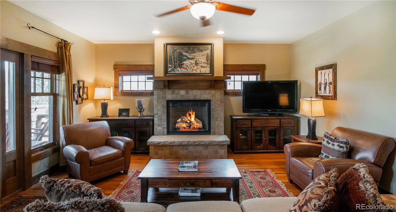 21 Meadow Trail Fraser, CO 80442 - Photo 13 of 36 a living room with furniture a flat screen tv and a fireplace