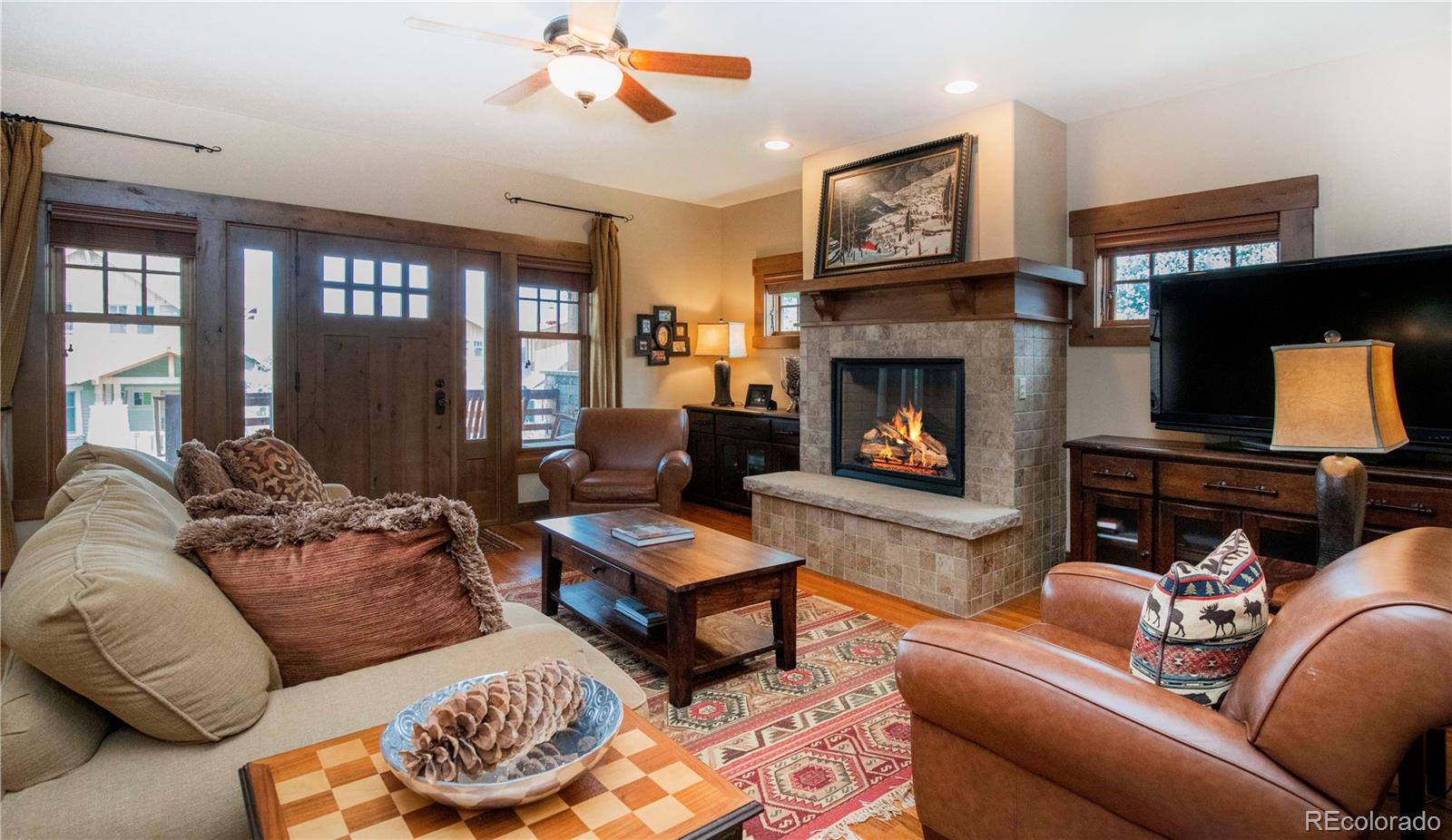 21 Meadow Trail Fraser, CO 80442 - Photo 14 of 36 a living room with furniture a fireplace and a flat screen tv
