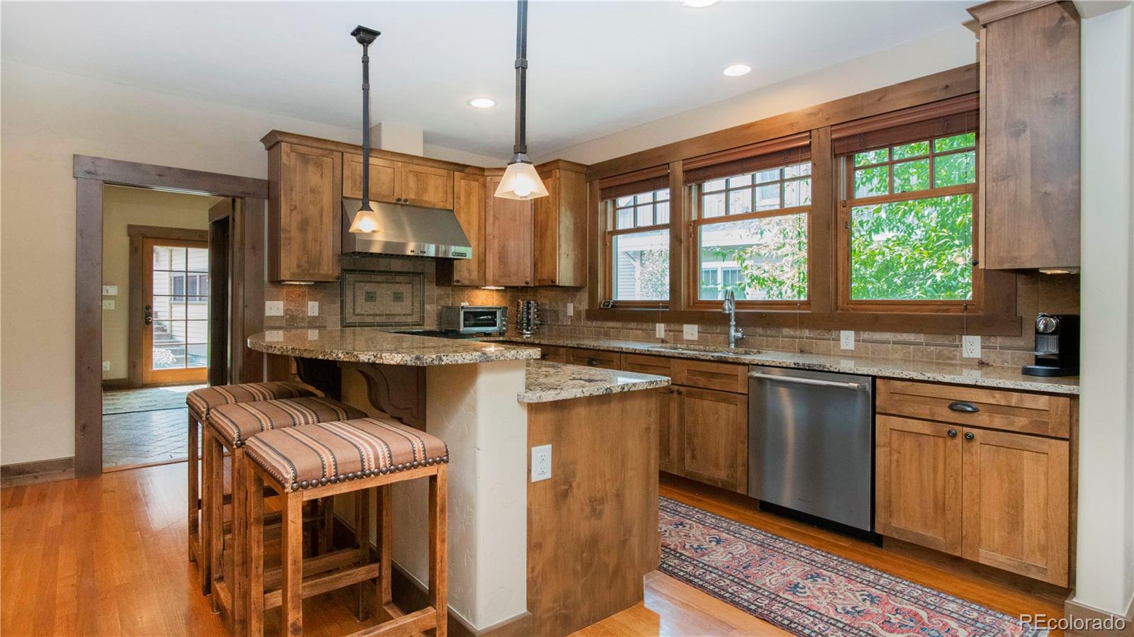 21 Meadow Trail Fraser, CO 80442 - Photo 17 of 36 a kitchen with stainless steel appliances granite countertop a sink a stove and a wooden floors