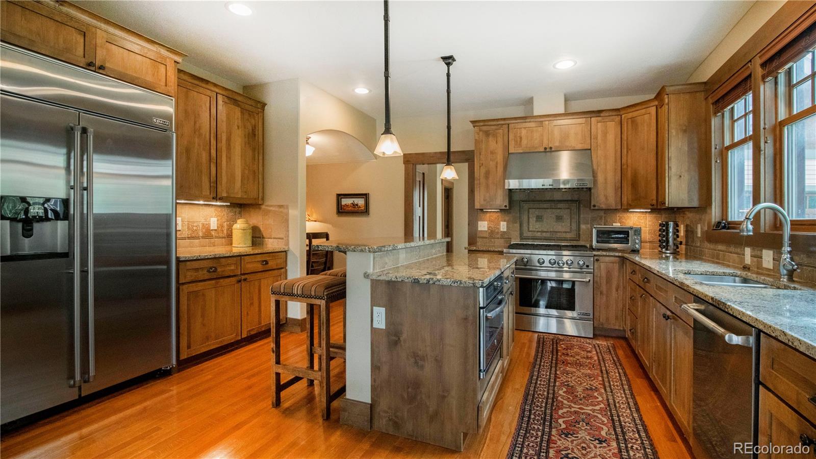 21 Meadow Trail Fraser, CO 80442 - Photo 19 of 36 a kitchen with stainless steel appliances granite countertop a refrigerator a stove a sink and a microwave
