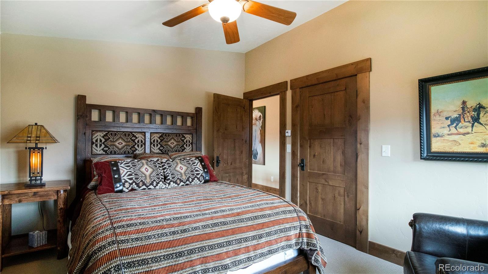 21 Meadow Trail Fraser, CO 80442 - Photo 23 of 36 a bedroom with a bed and a painting on the wall