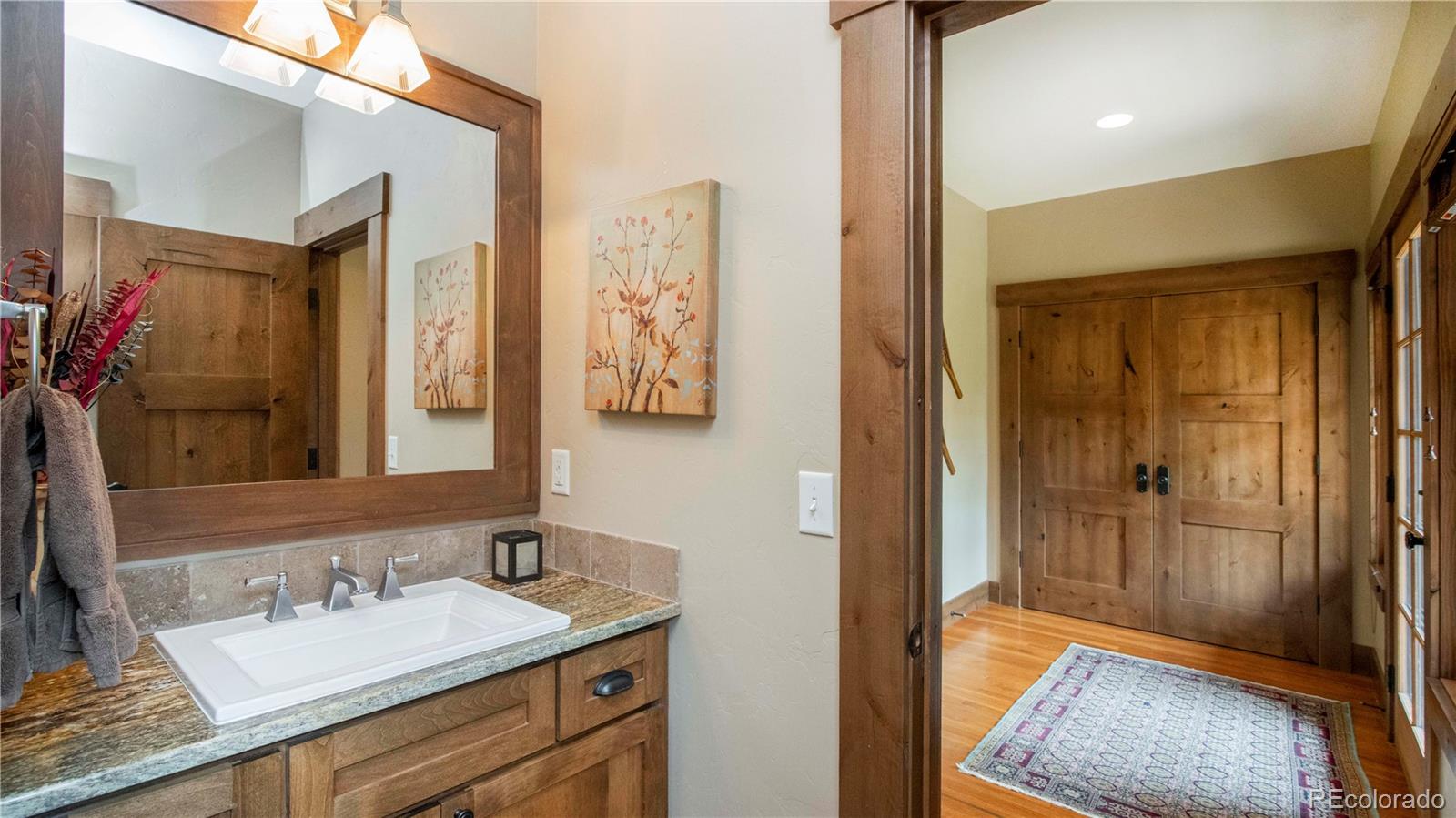 21 Meadow Trail Fraser, CO 80442 - Photo 25 of 36 a bathroom with a sink a mirror and a shower