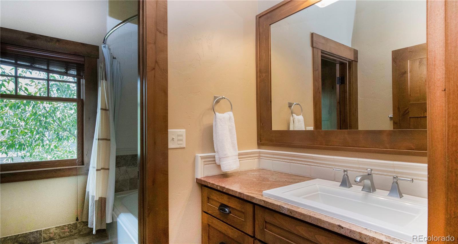 21 Meadow Trail Fraser, CO 80442 - Photo 30 of 36 a bathroom with a sink and a mirror