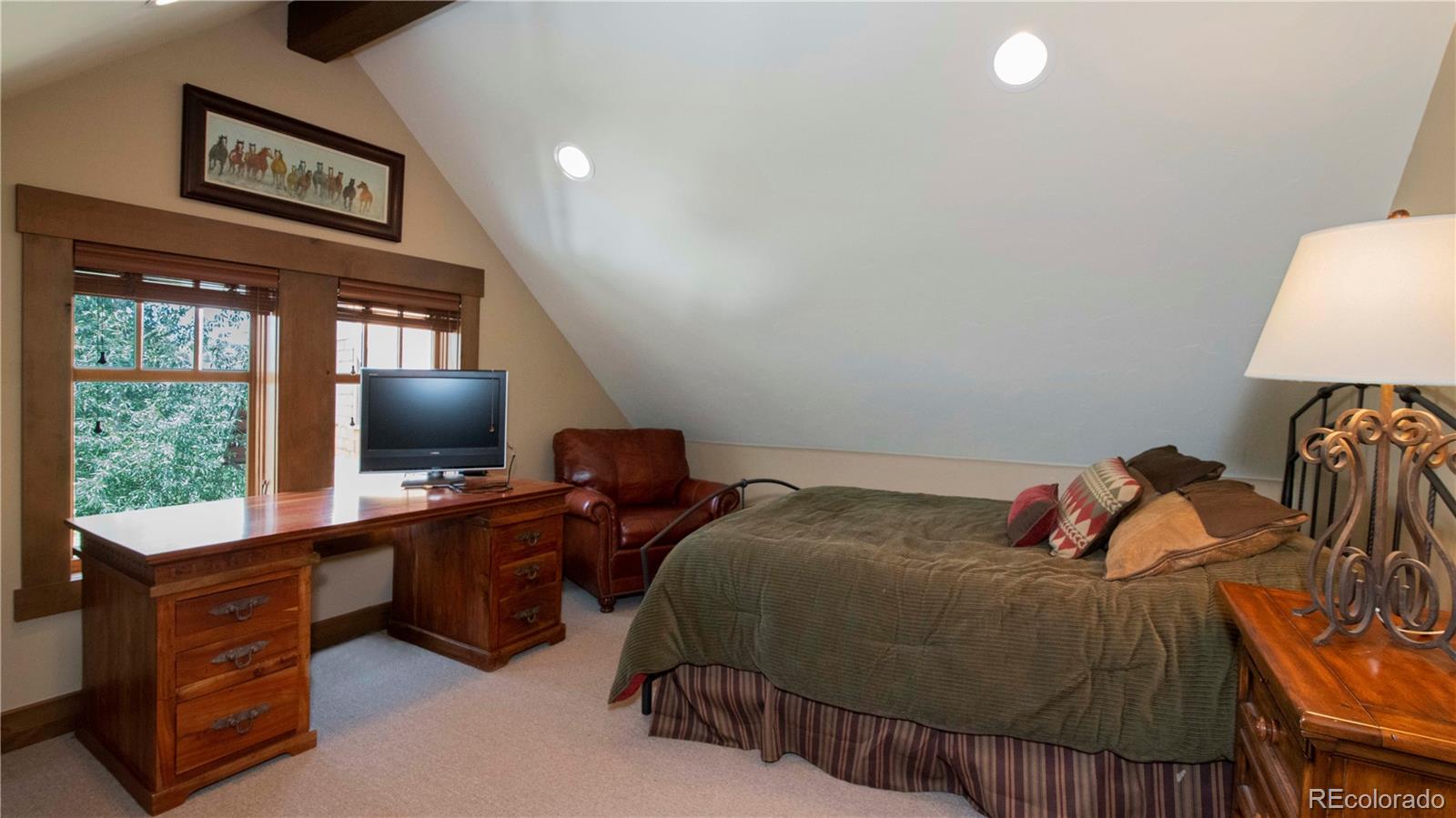 21 Meadow Trail Fraser, CO 80442 - Photo 33 of 36 a bedroom with a bed and a flat screen tv