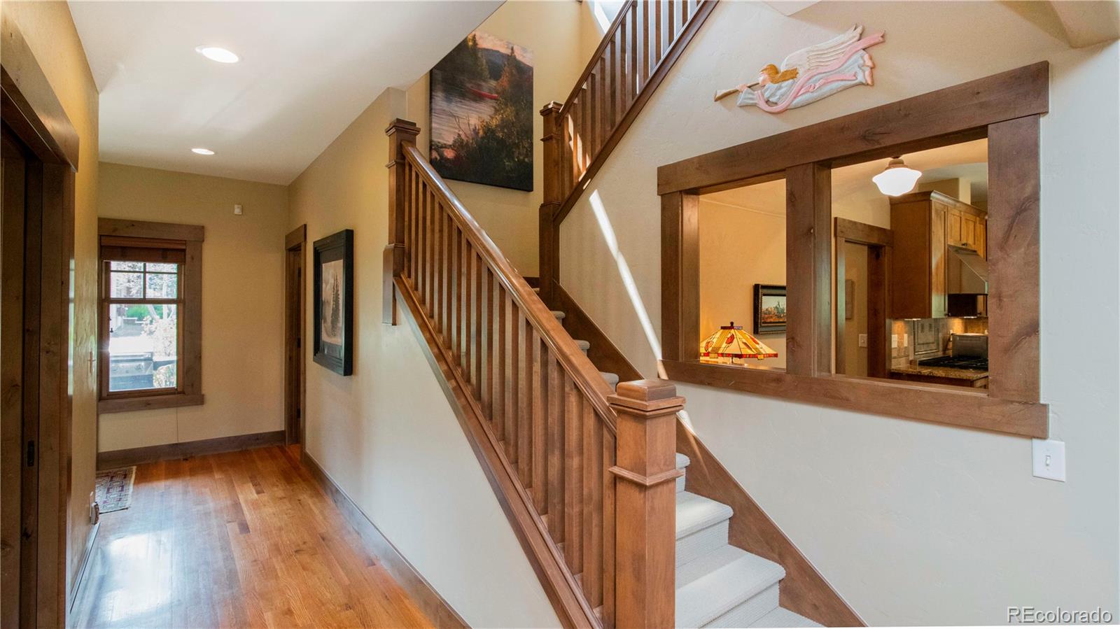 21 Meadow Trail Fraser, CO 80442 - Photo 8 of 36 a view of a hallway with wooden floor and stairs