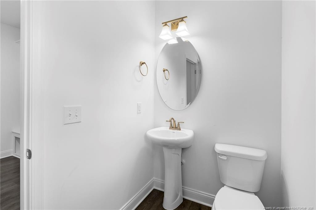 176 Josey Williams Road Erwin, NC 28339 - Photo 22 of 40 a bathroom with a toilet sink and mirror