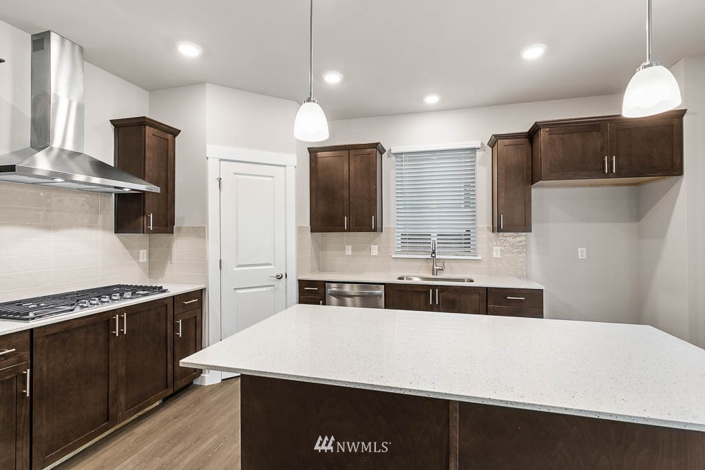 6 180th Place Southeast, Unit 34 Bothell, WA 98012 - Photo 14 of 36 a kitchen with kitchen island a sink stainless steel appliances and counter space