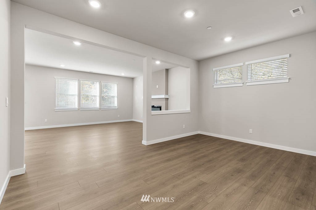 6 180th Place Southeast, Unit 34 Bothell, WA 98012 - Photo 9 of 36 an empty room with wooden floor and windows
