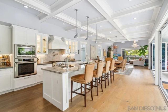 a kitchen with appliances a sink a counter top space and cabinets