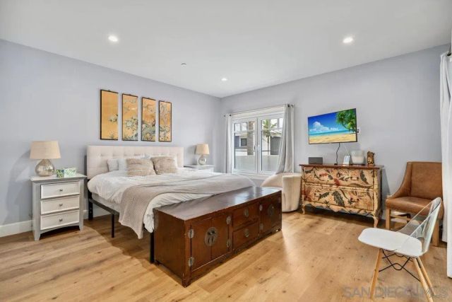 a spacious bedroom with a bed and a couch