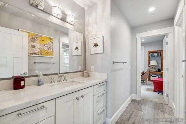 a bathroom with a sink a vanity and a mirror