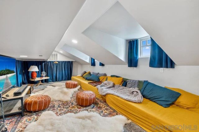 a bed room with two bed and a chair