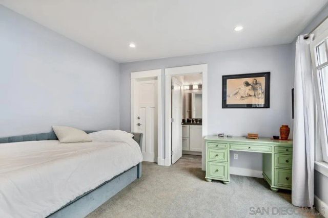 a bedroom with a bed and a desk