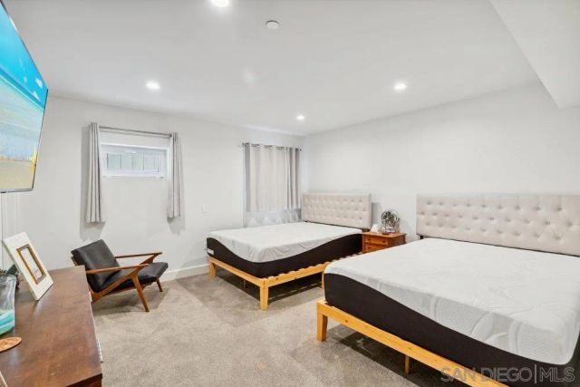 a bedroom with two beds and painted walls