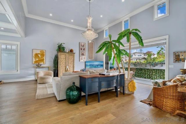 a living room with furniture a chandelier and a rug