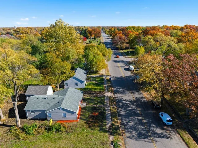 an aerial view of a house with a yard