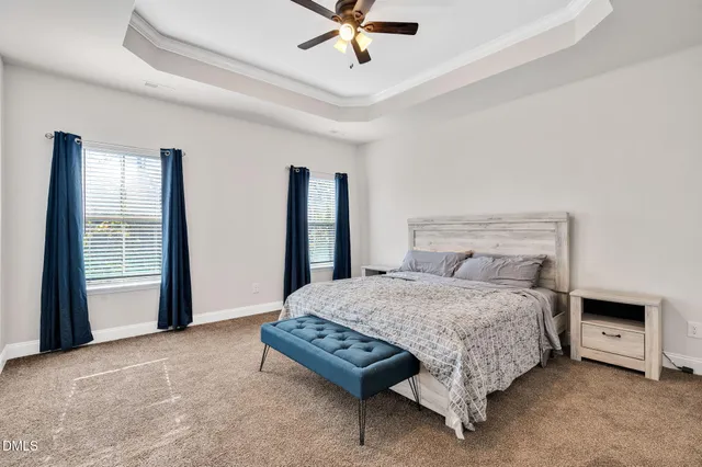 a bedroom with a bed and a ceiling fan