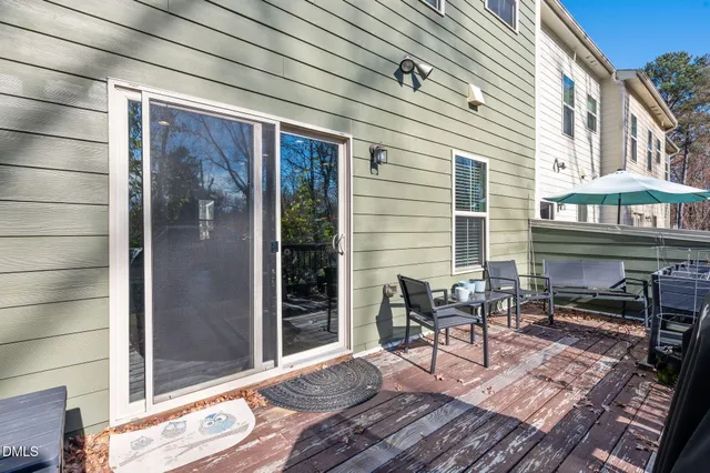 a view of a patio with table and chairs and wooden floor