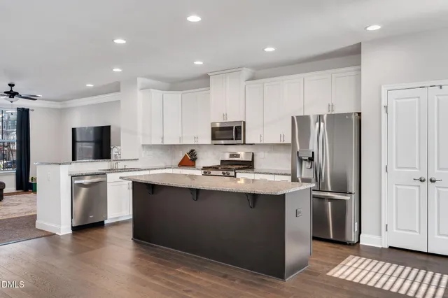 a kitchen with stainless steel appliances a refrigerator stove microwave and sink