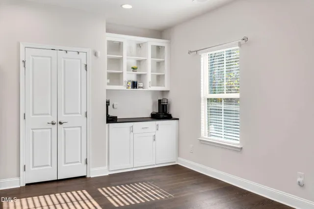 a room with a window and a dresser