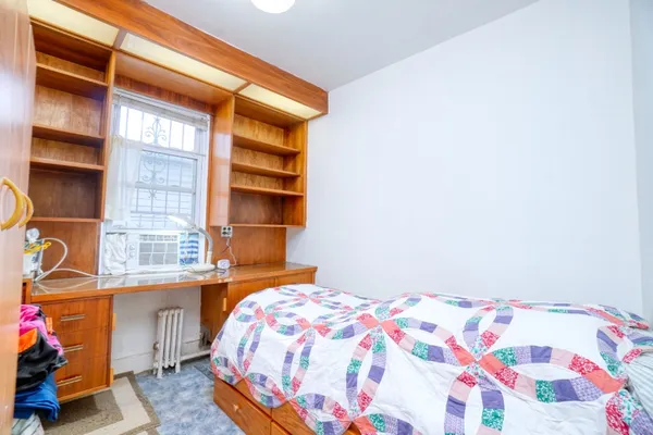 a bedroom with a bed and a window