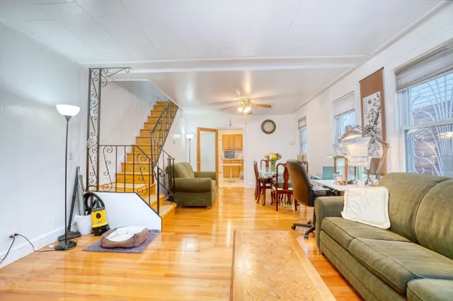 a living room with furniture a rug and a large window