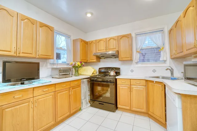 a kitchen with stainless steel appliances granite countertop a stove sink and cabinets