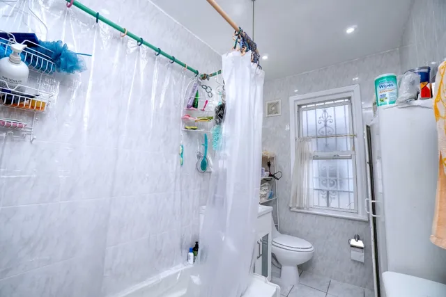 a bathroom with a toilet and shower
