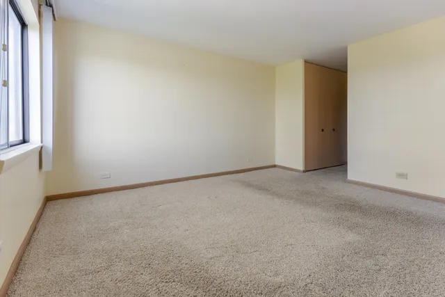 a view of an empty room and a window