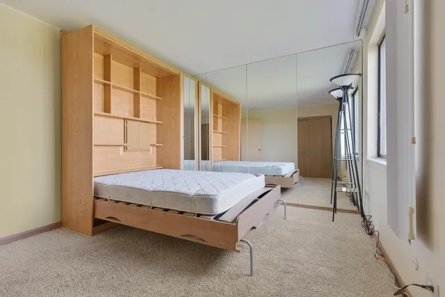 a bed room with a bed and a window