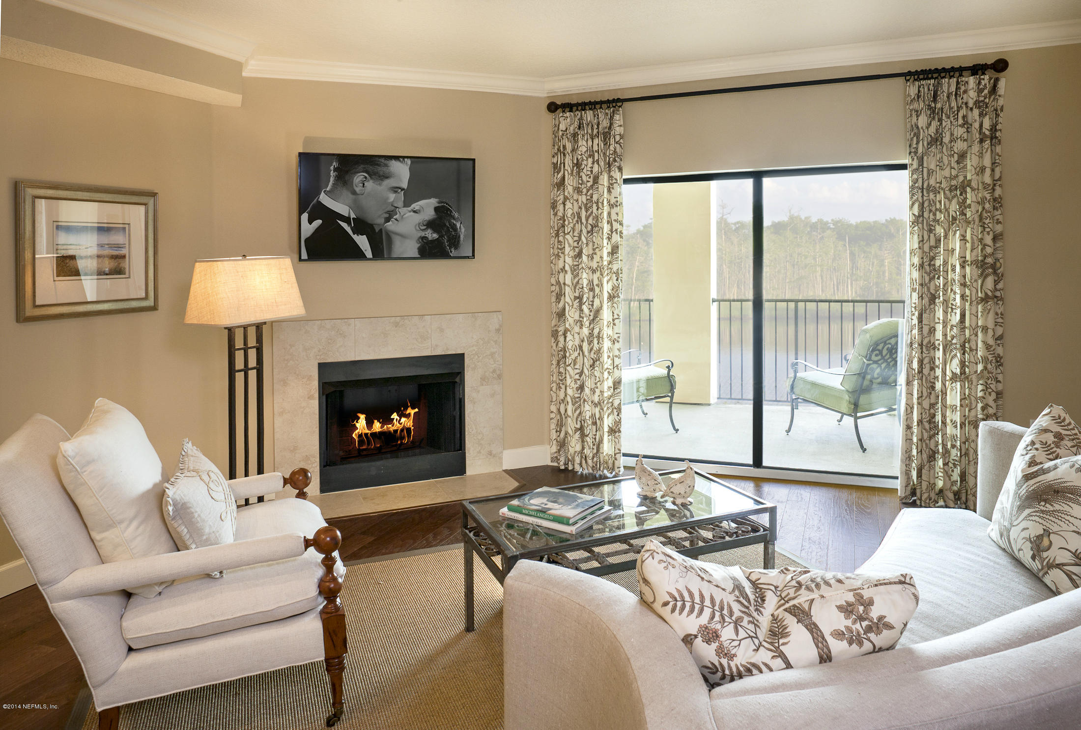 3958 Baymeadows Road, Unit 1601 Jacksonville, FL 32217 - Photo 3 of 9 a living room with furniture and a fireplace