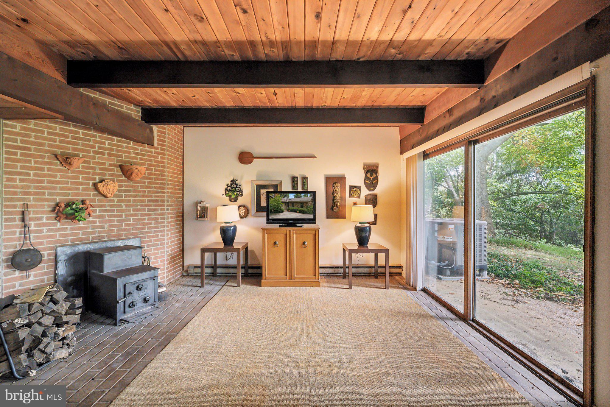 39773 Thomas Mill Road Leesburg, VA 20175 - Photo 20 of 27 lower level with high ceilings, a wood-stove