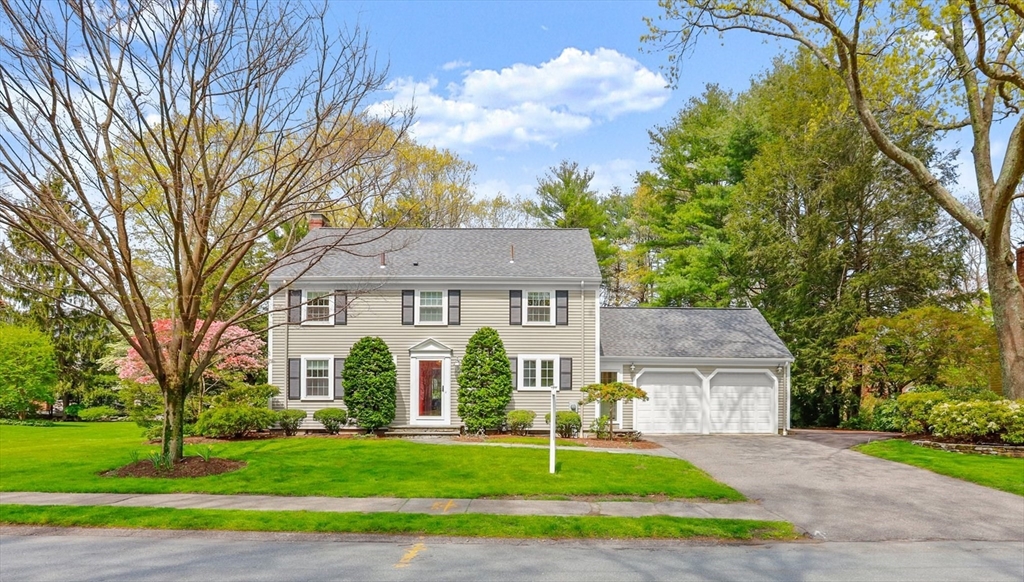 109 Suffolk Road Wellesley, MA 02481 - Photo 1 of 24 a front view of a house with a yard and garage