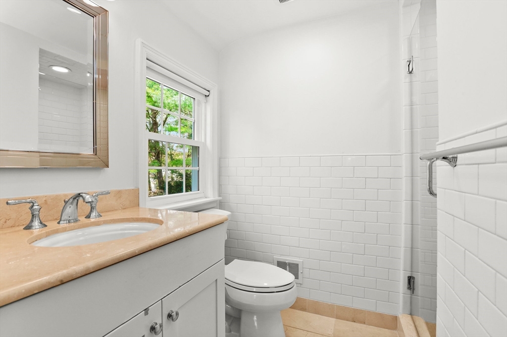 109 Suffolk Road Wellesley, MA 02481 - Photo 12 of 24 a bathroom with a granite countertop sink a toilet and a mirror